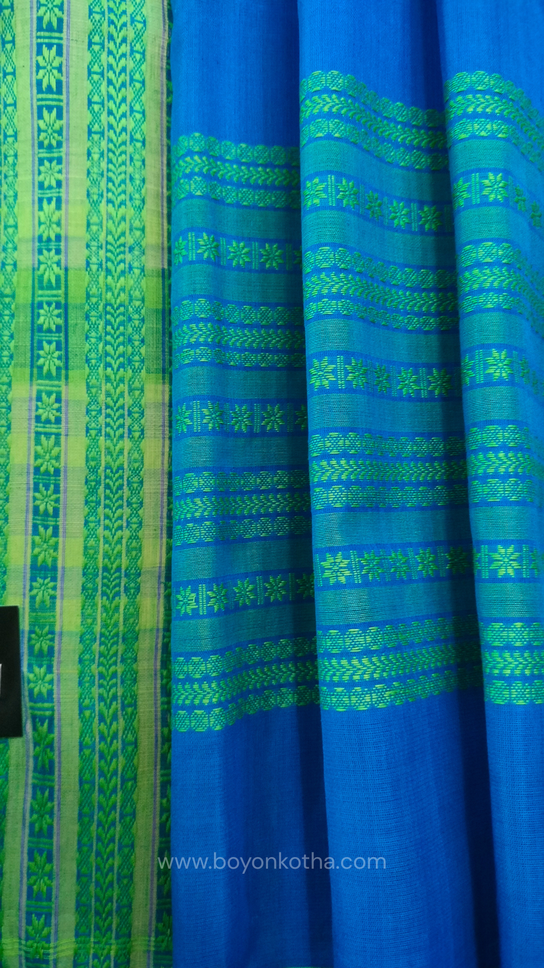Royal blue handwoven mercerized cotton saree with Manipuri-inspired thread work pattern in green. Durable, breathable Bengal handloom saree for festive wear.