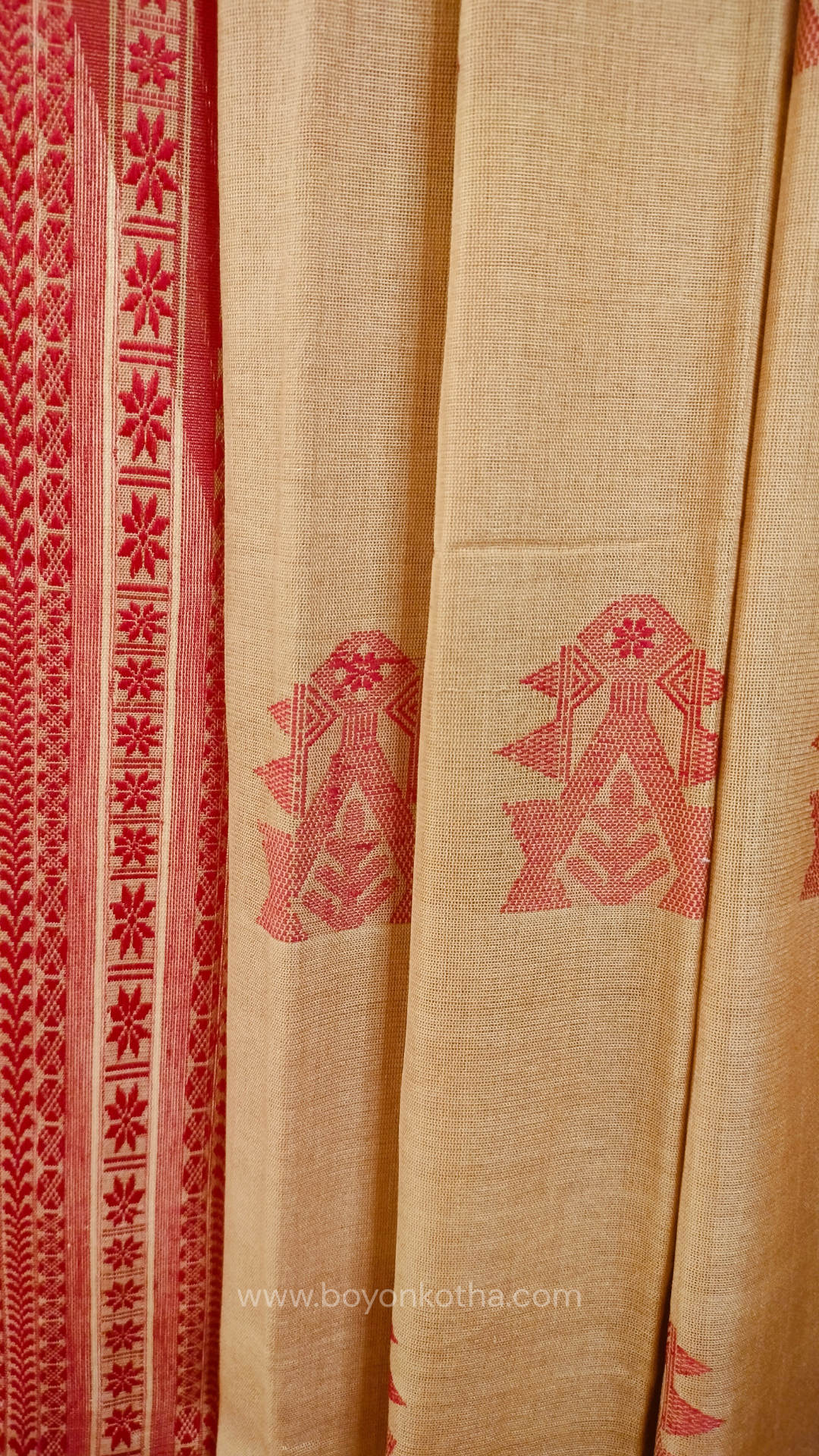 Beige handwoven mercerized cotton saree with Manipuri-inspired thread work pattern in red. Durable, breathable Bengal handloom saree for festive wear.