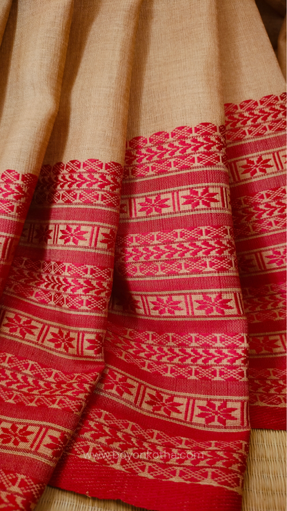 Beige handwoven mercerized cotton saree with Manipuri-inspired thread work pattern in red. Durable, breathable Bengal handloom saree for festive wear.