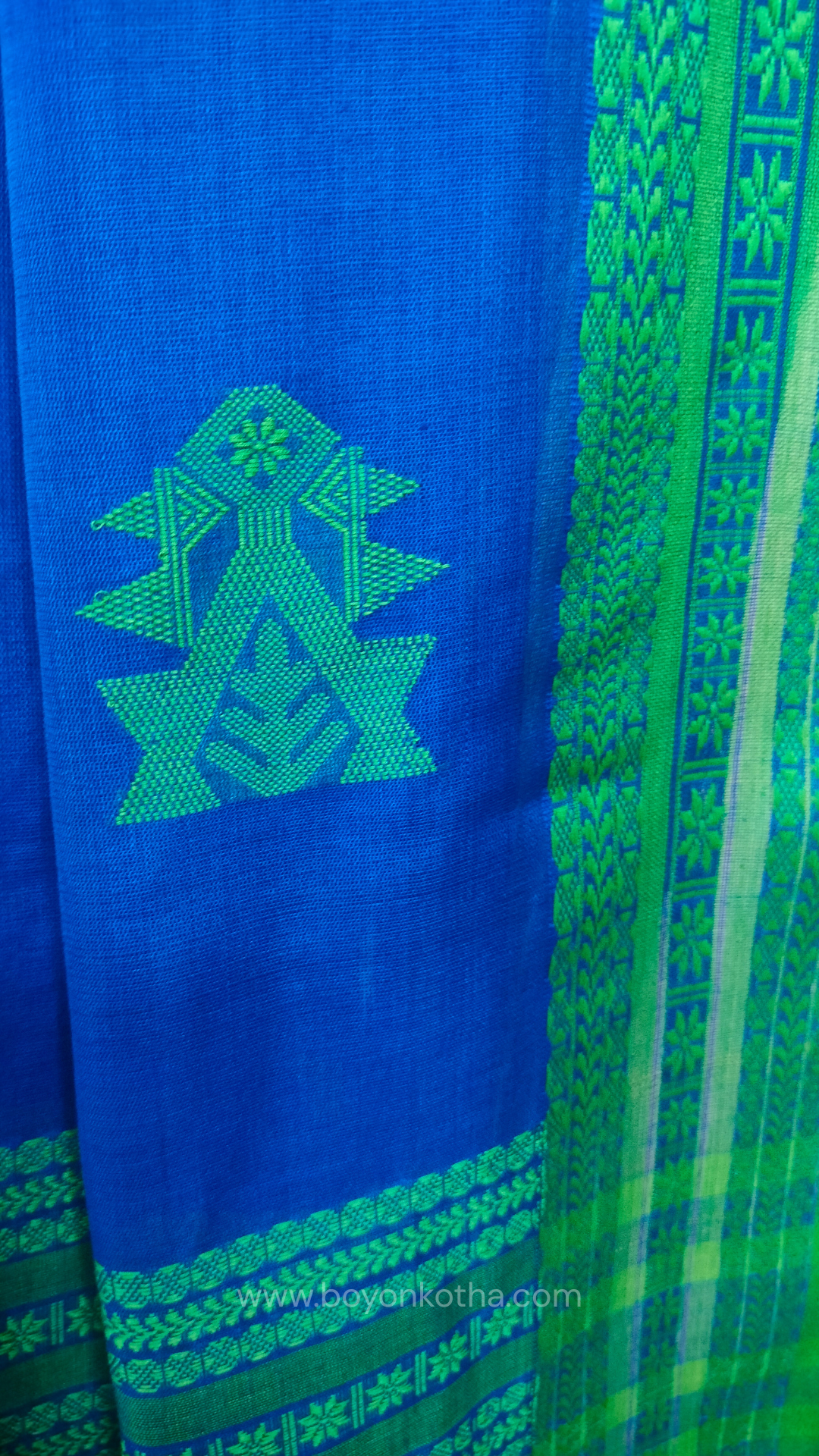 Royal blue handwoven mercerized cotton saree with Manipuri-inspired thread work pattern in green. Durable, breathable Bengal handloom saree for festive wear.