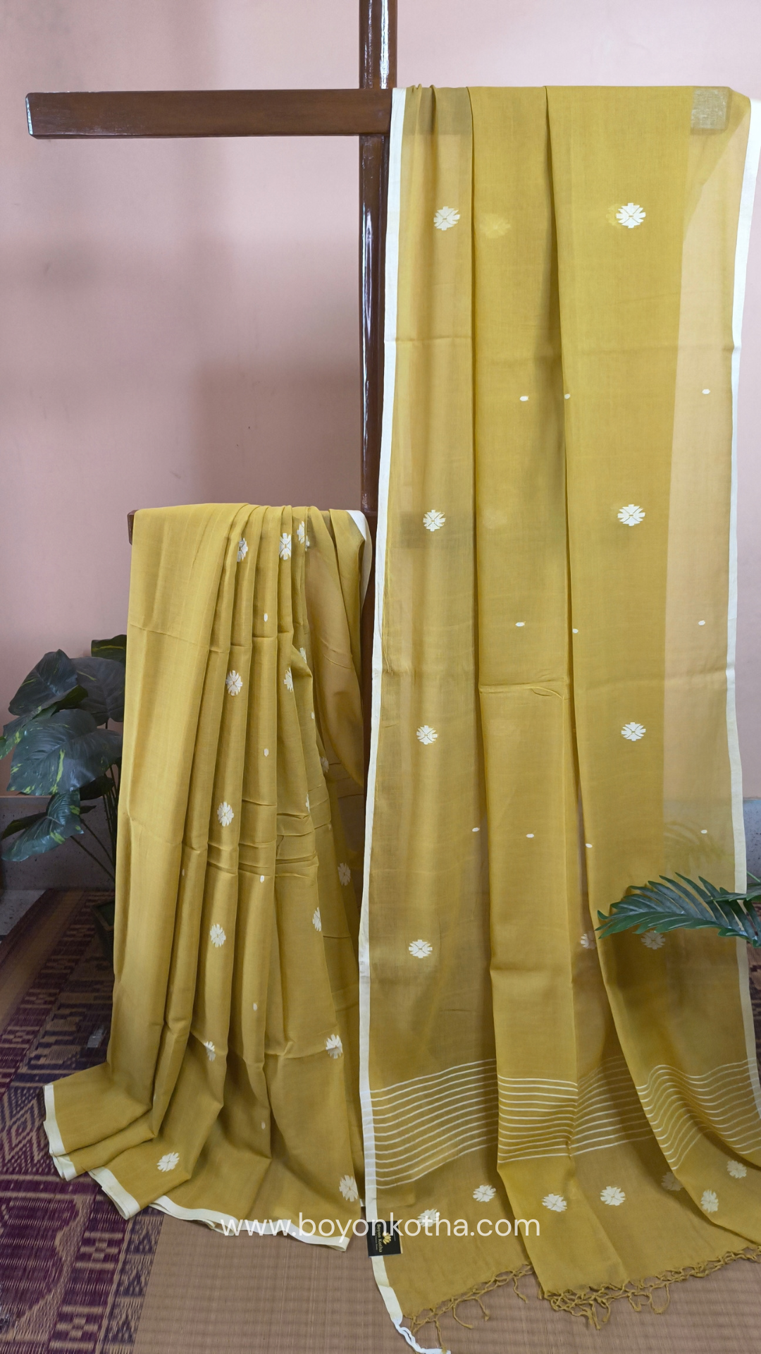 Greenish yellow buttery soft handloom cotton saree, with jamdani inspired handloom jacquard woven butas all over and braided tassels. Ideal for festive mornings 