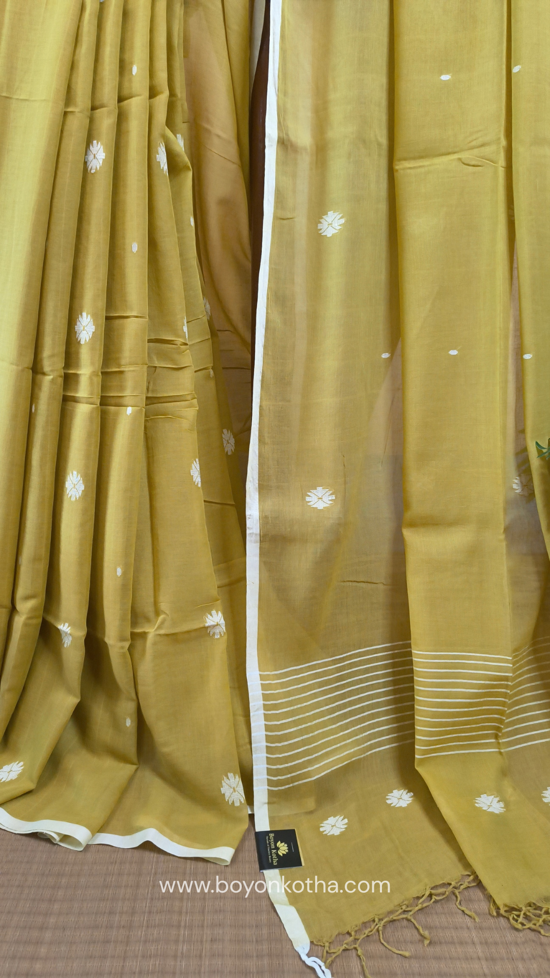 Greenish yellow buttery soft handloom cotton saree, with jamdani inspired handloom jacquard woven butas all over and braided tassels. Ideal for festive mornings 