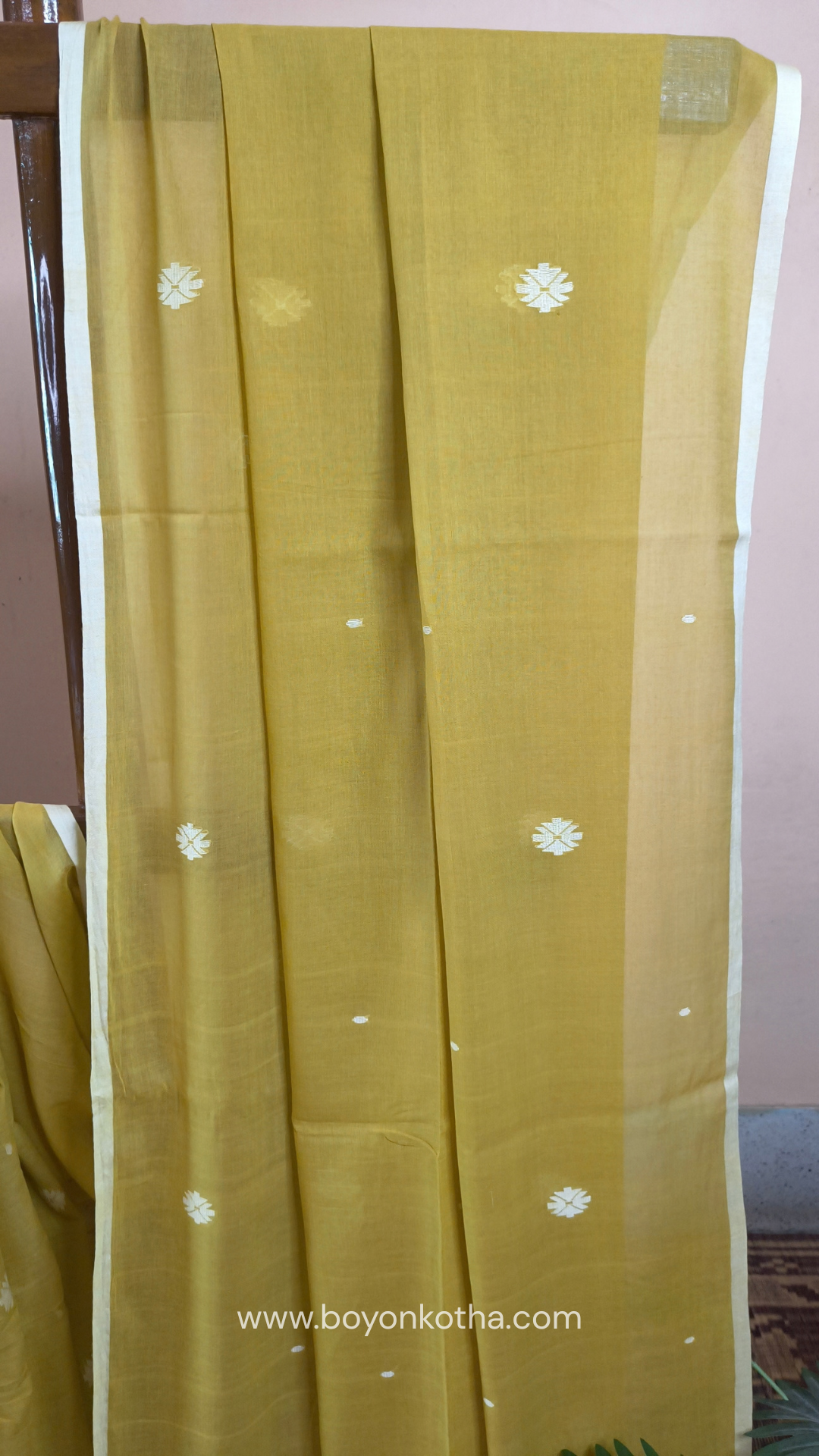 Greenish yellow buttery soft handloom cotton saree, with jamdani inspired handloom jacquard woven butas all over and braided tassels. Ideal for festive mornings 