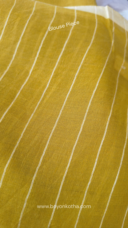 Greenish yellow buttery soft handloom cotton saree, with jamdani inspired handloom jacquard woven butas all over and braided tassels. Ideal for festive mornings 