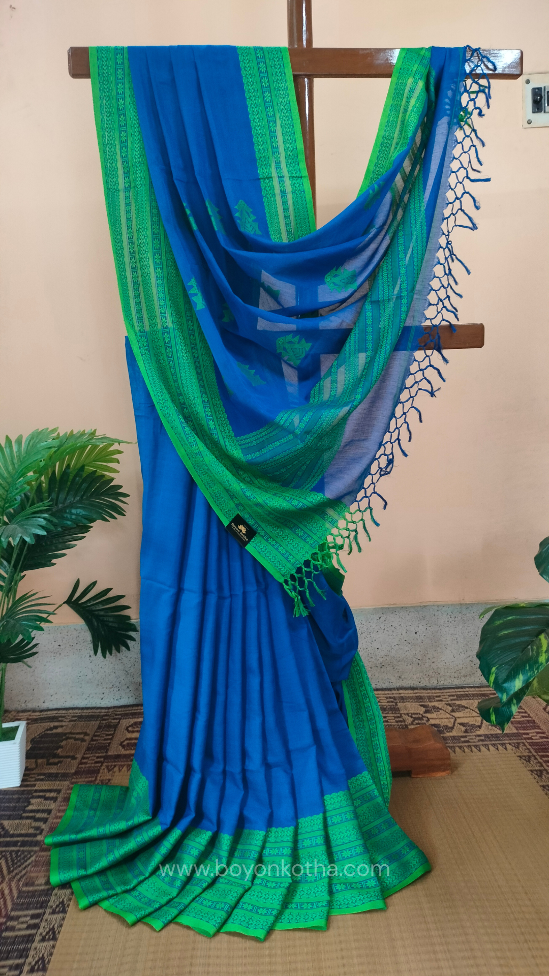 Royal blue handwoven mercerized cotton saree with Manipuri-inspired thread work pattern in green. Durable, breathable Bengal handloom saree for festive wear.