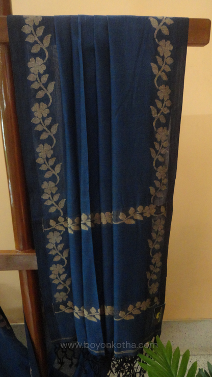 Blue handwoven cotton saree, with woven beige floral vines running across the border till the pallu; bengal handloom, blue saree