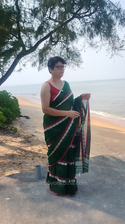 Green saree, handloom cotton, Dhonekhali weave, with red and white woven motifs across the saree