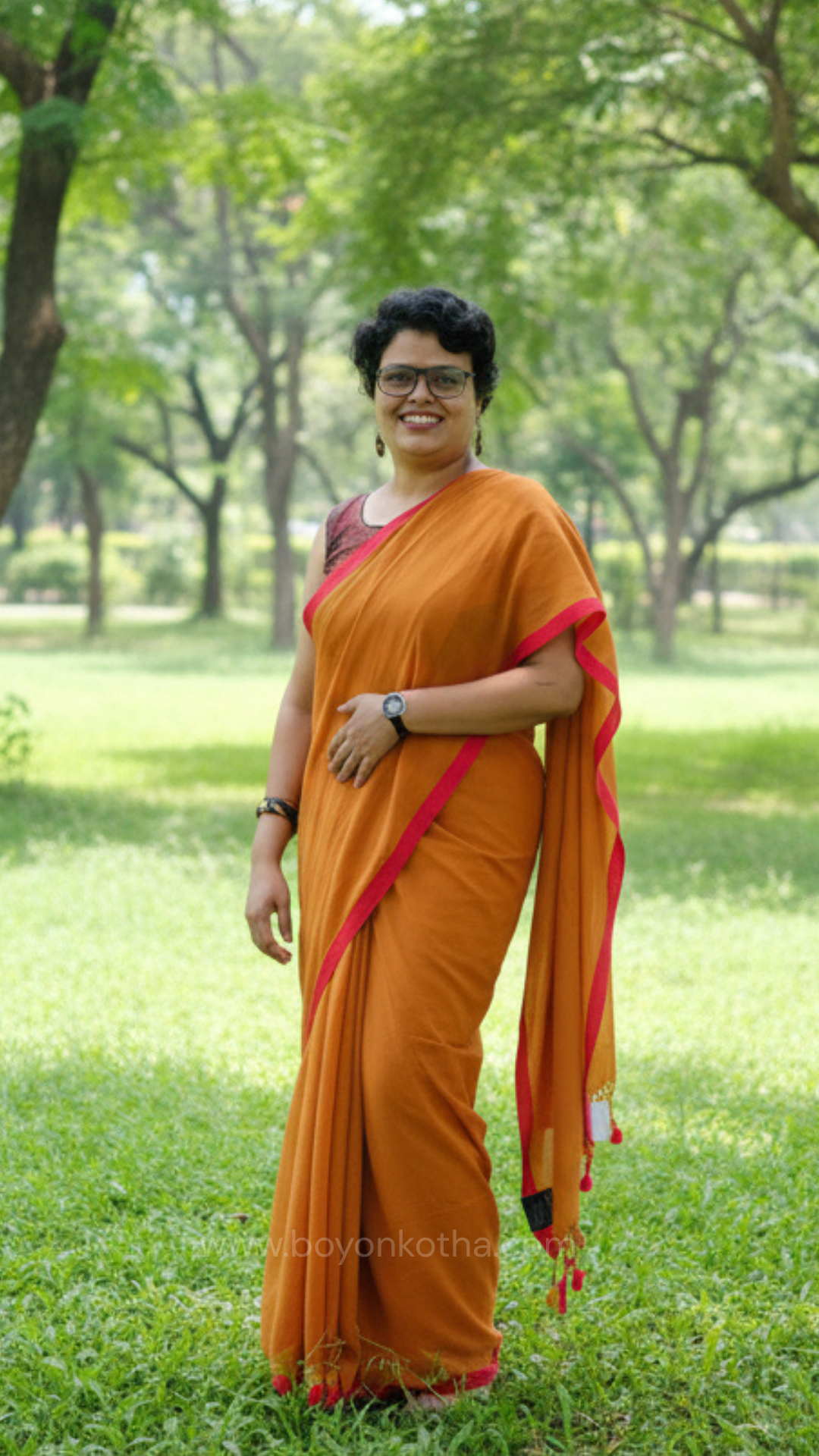 Mustard yellow handwoven mul cotton saree with red border, pallu ending in tassels. Plain handloom mustard yellow saree from Bengal.