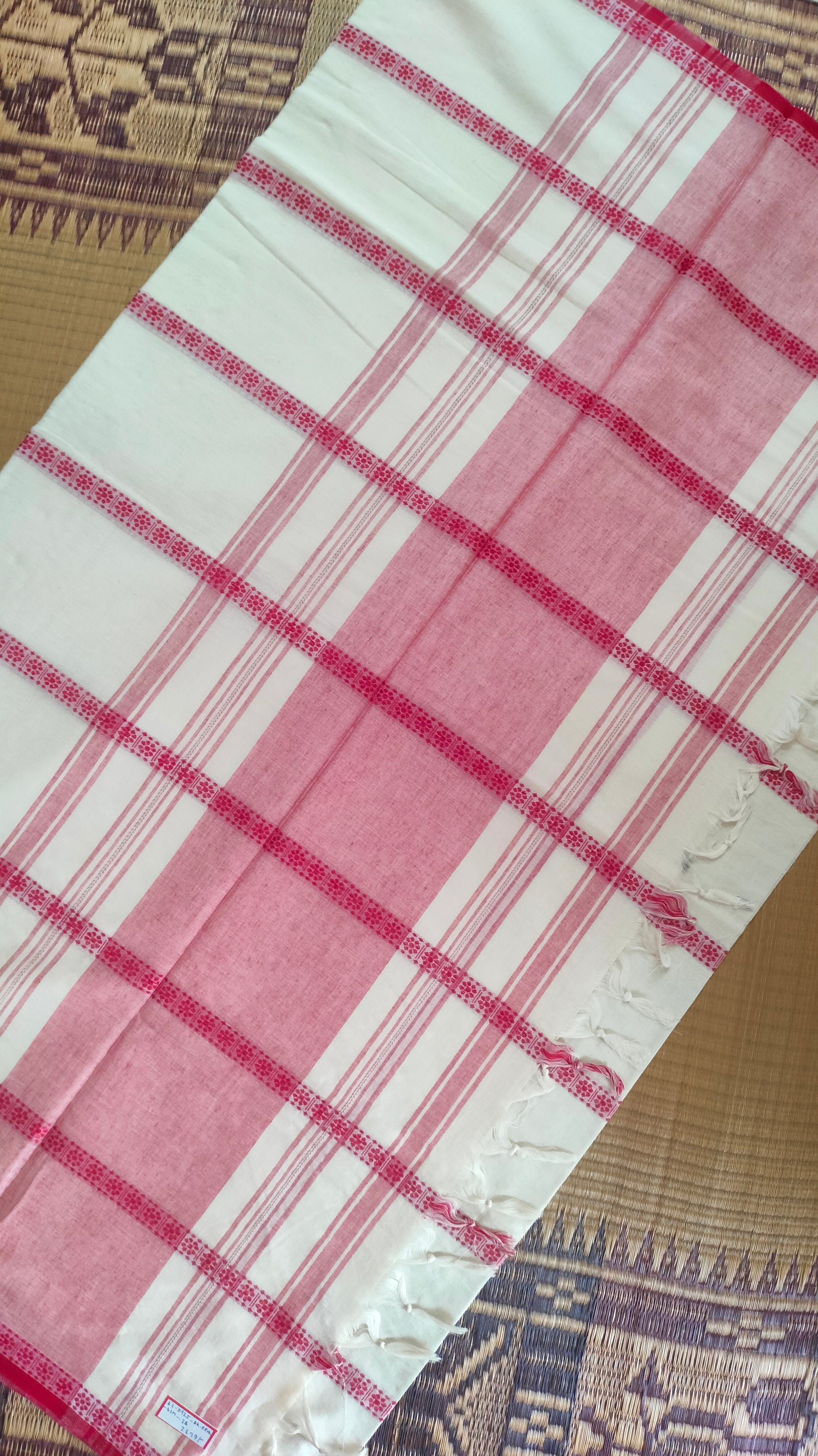 Red and white cotton saree. Lightweight, breathable handloom cotton saree, with multiple woven motifs bands running horizontally across the body till the pallu. Perfect for casual everyday wear and festive occasion.