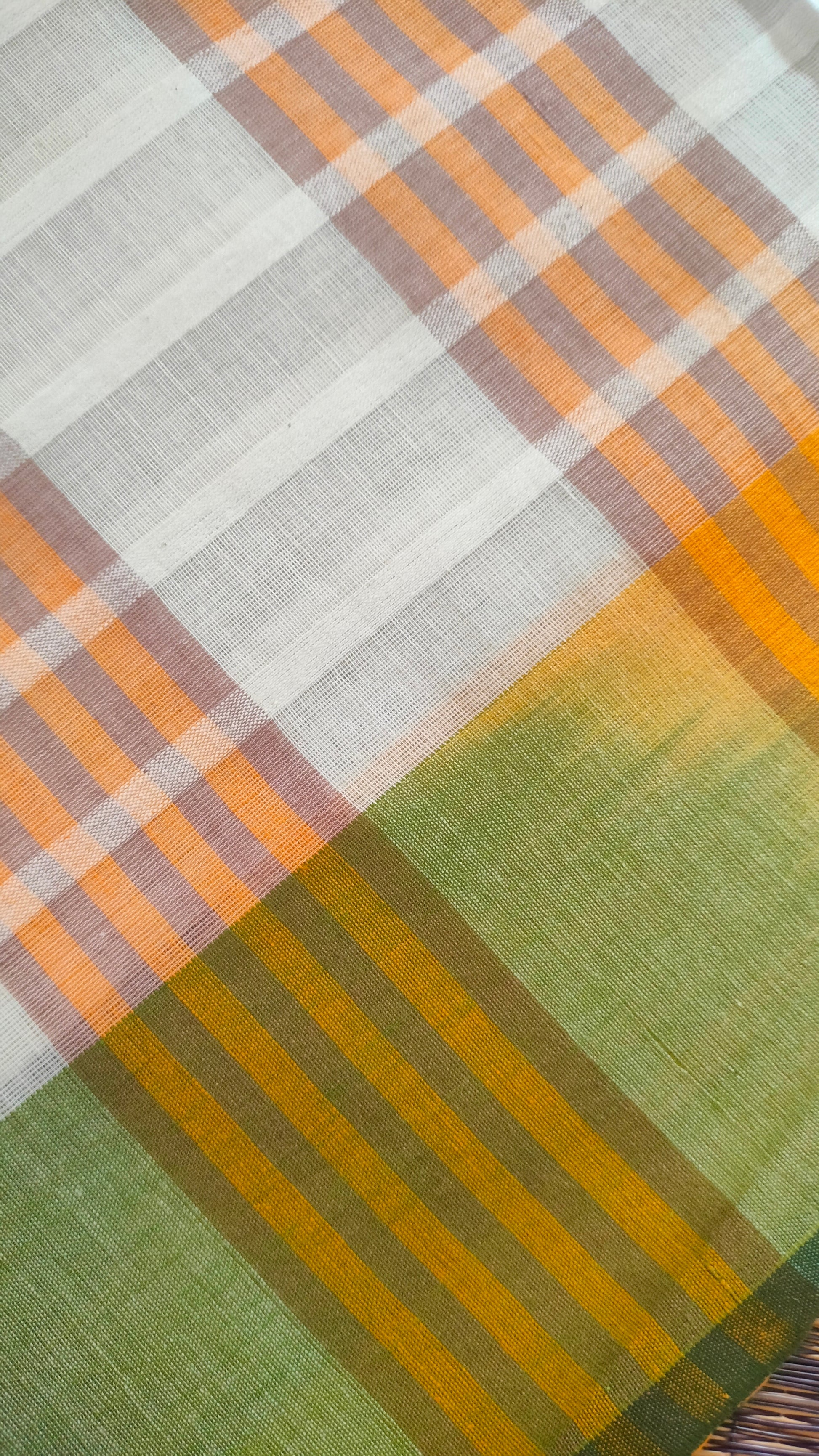 Dhonekhali handloom cotton saree with a striped body in alternating off-white and cream tones, complemented by a vibrant multi-hued border in green, purple, and yellow abstract patterns. Finished with tassel details at the pallu.