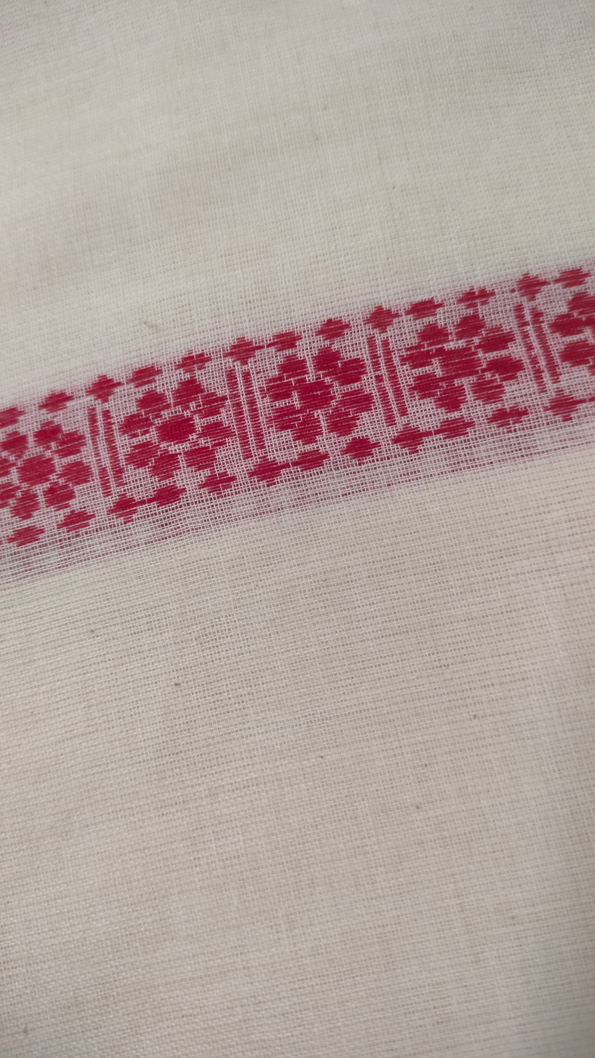 Red and white cotton saree. Lightweight, breathable handloom cotton saree, with multiple woven motifs bands running horizontally across the body till the pallu. Perfect for casual everyday wear and festive occasion.