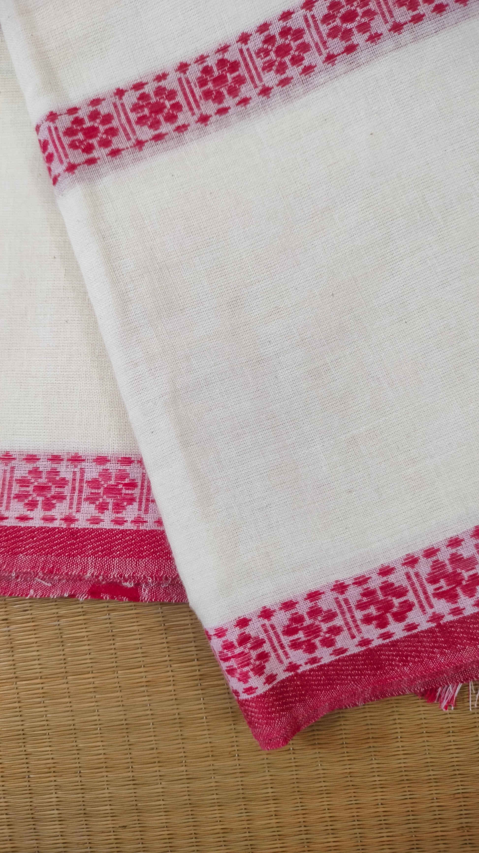 Red and white cotton saree. Lightweight, breathable handloom cotton saree, with multiple woven motifs bands running horizontally across the body till the pallu. Perfect for casual everyday wear and festive occasion.