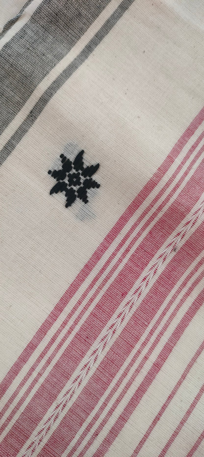 Close-up of pallu showing black motif of a red, black and white Dhonekhali cotton saree.