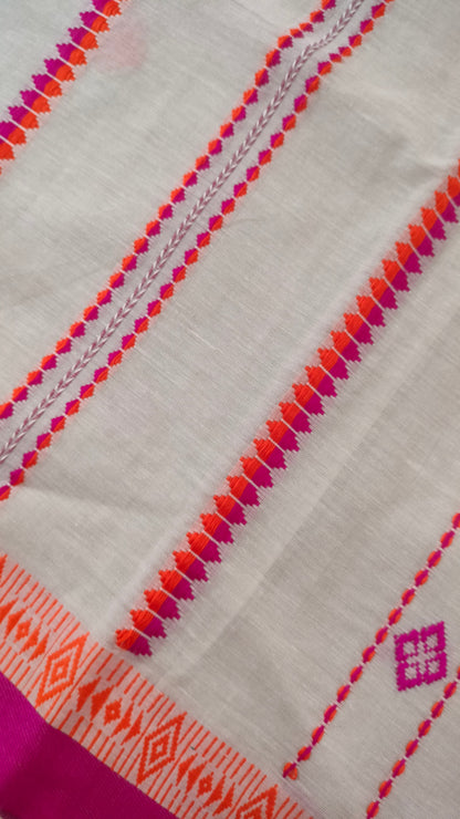 A white Dhonekhali handloom cotton saree with orange and pink woven motifs and bands on the saree. The border of the saree is pink with the inner edge having orange motifs.
