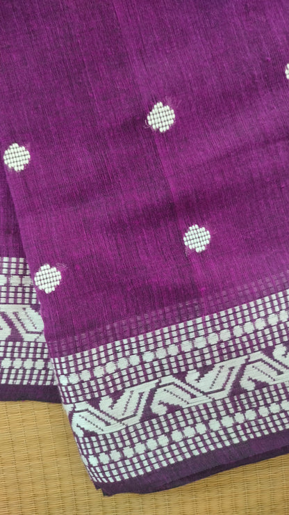 Purple Dhonekhali handloom cotton saree with woven white motifs across the body and the border with a black pallu that has woven white vertical stripes.