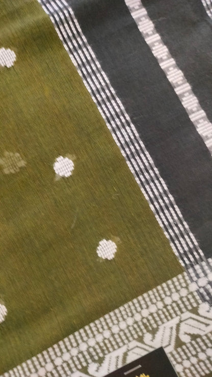 Olive Green Dhonekhali handloom cotton saree with woven white motifs across the body and the border with a black pallu that has woven white vertical stripes.