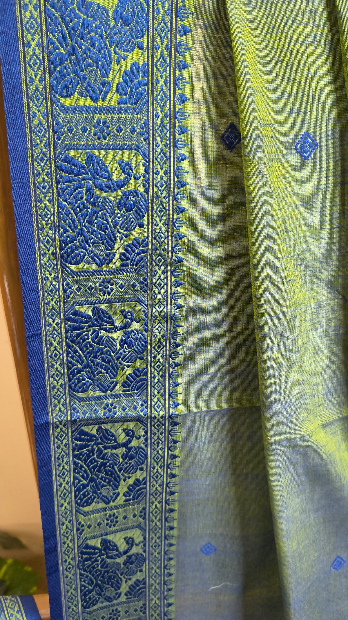 Dual toned green-blue cotton baluchari saree, with woven motifs in the border & pallu in navy blue. Bengal handloom ideal for festivals & everyday celebrations.
