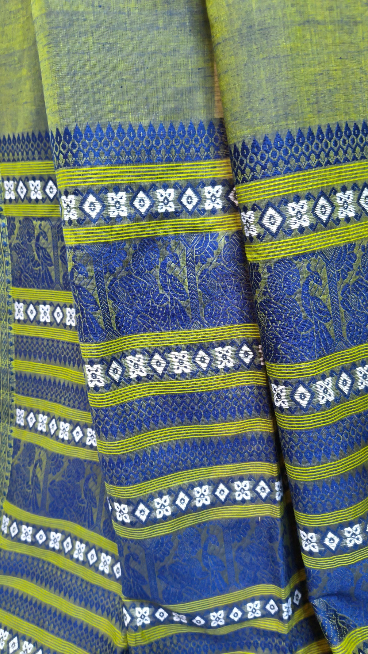 Dual toned green-blue cotton baluchari saree, with woven motifs in the border & pallu in navy blue. Bengal handloom ideal for festivals & everyday celebrations.