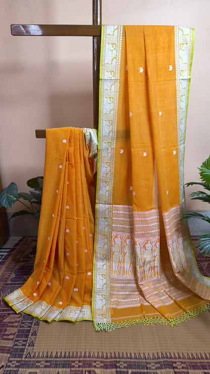 Orange cotton baluchari saree, with woven motifs in the border & pallu in white and neon green. Bengal handloom ideal for festivals & everyday celebrations.