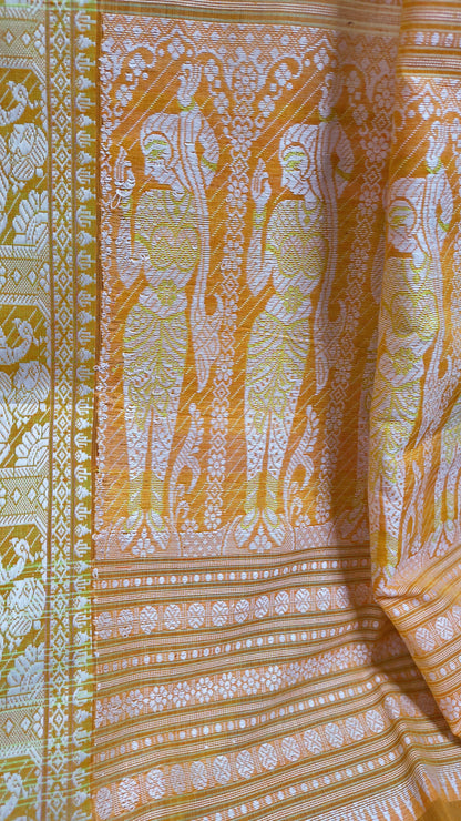 Orange cotton baluchari saree, with woven motifs in the border & pallu in white and neon green. Bengal handloom ideal for festivals & everyday celebrations.