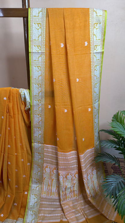Orange cotton baluchari saree, with woven motifs in the border & pallu in white and neon green. Bengal handloom ideal for festivals & everyday celebrations.