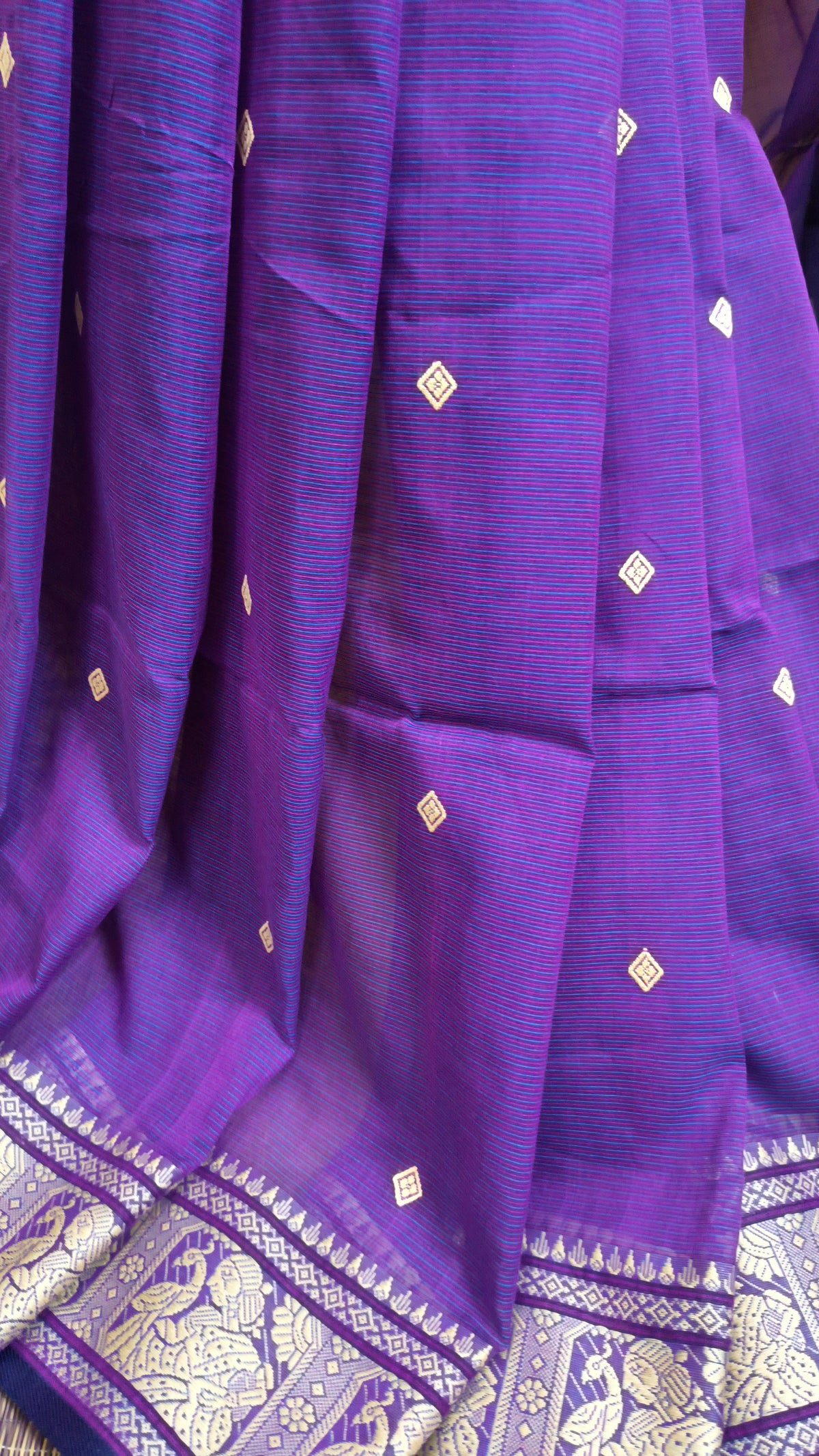 Purple cotton baluchari saree, with woven motifs in the border & pallu in beige. Bengal handloom ideal for festivals & everyday celebrations.