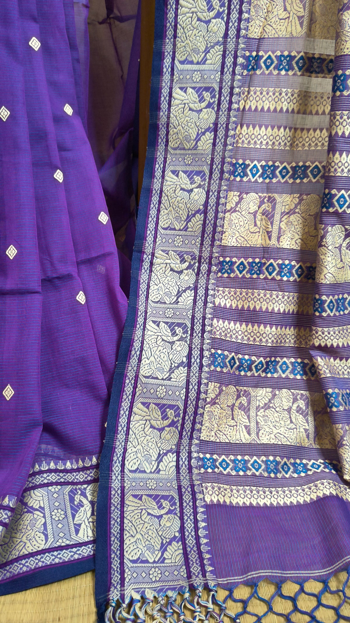 Purple cotton baluchari saree, with woven motifs in the border & pallu in beige. Bengal handloom ideal for festivals & everyday celebrations.